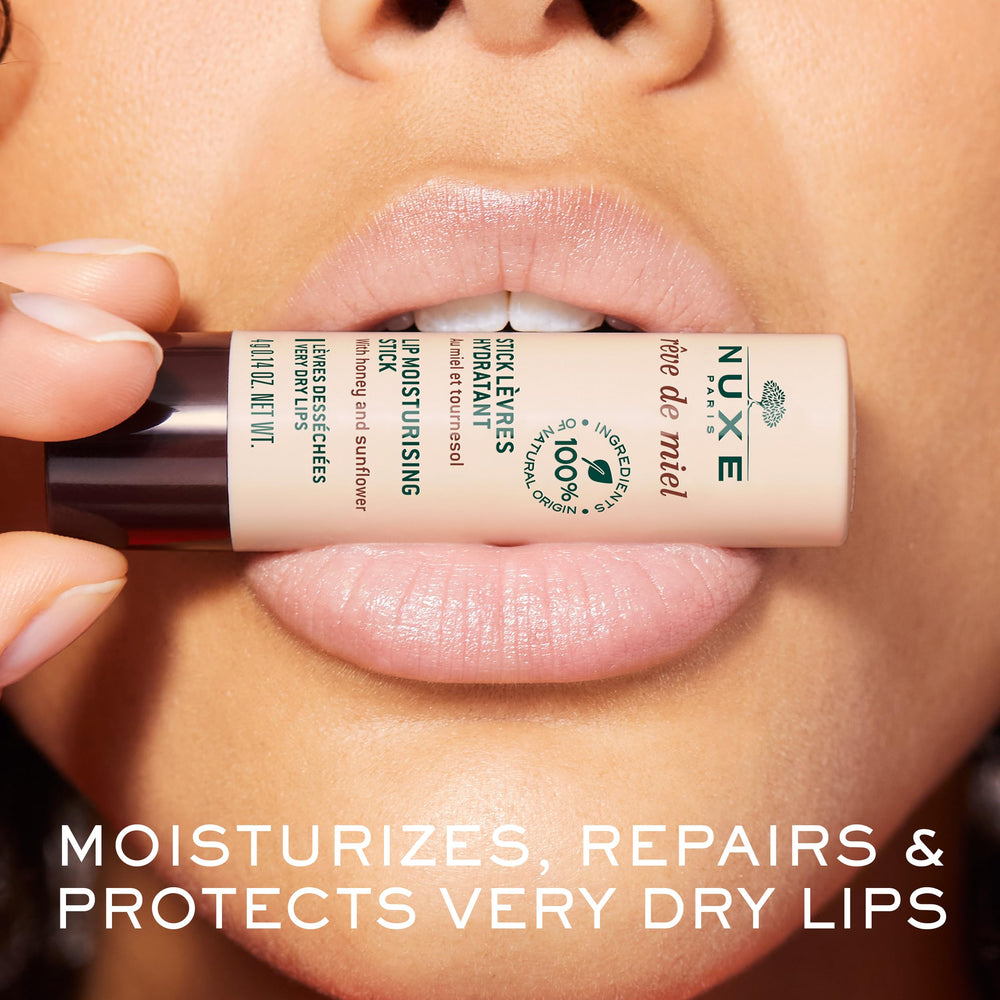 Nuxe Réve de Miel lip stick in hand for smooth glide and comfort.