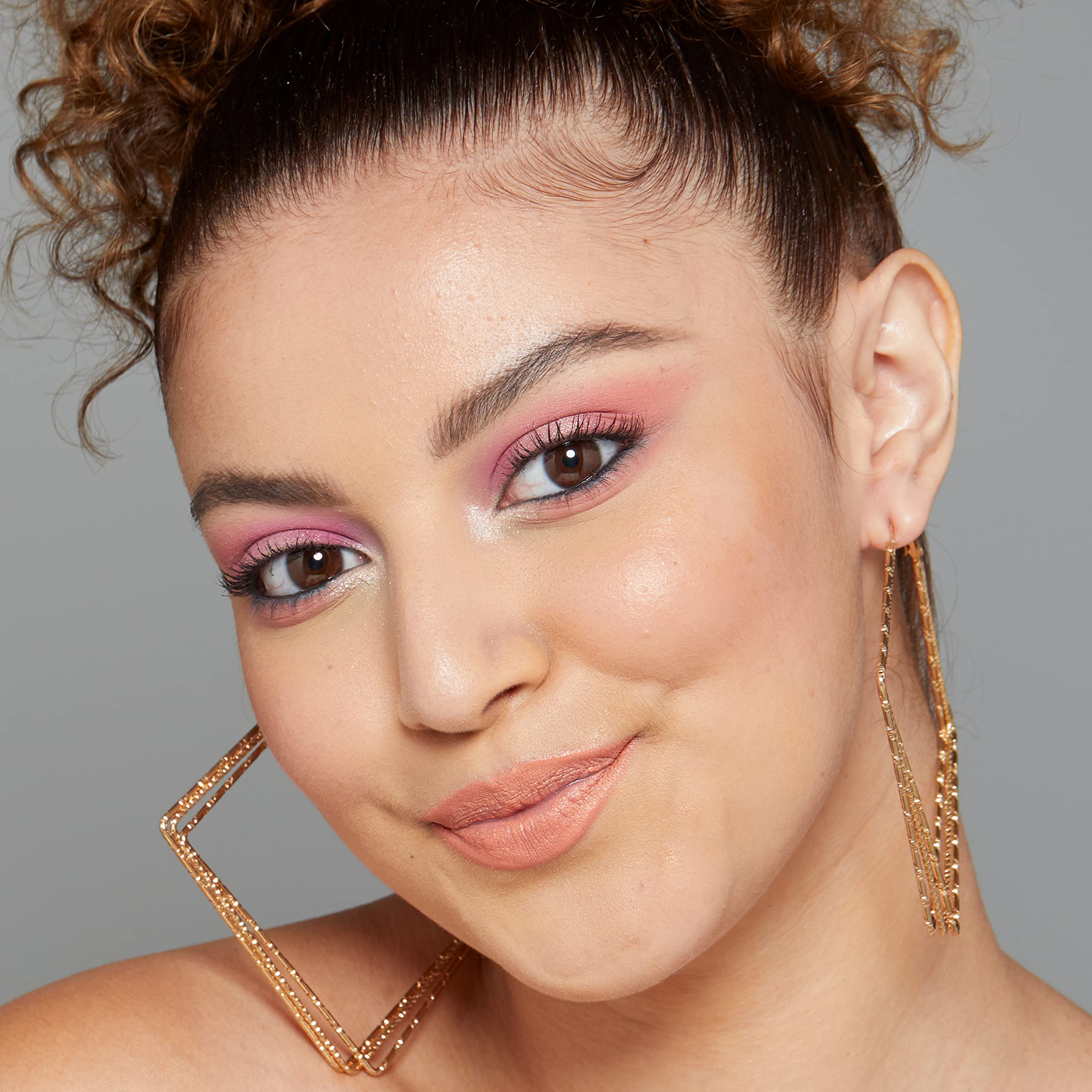 Fine mist from NYX Radiant Finish on skin for glow