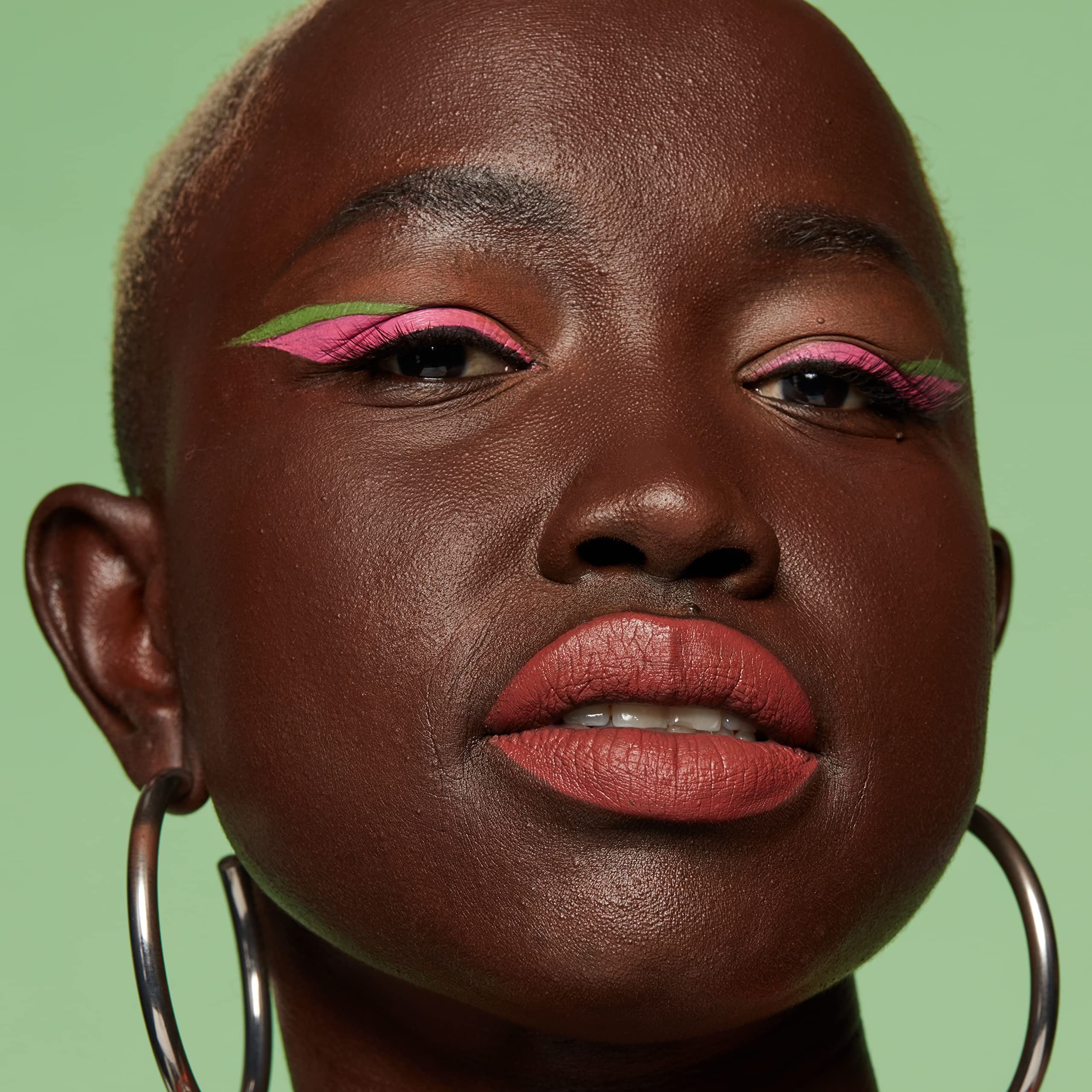 Precise-tip close-up on NYX Sneaky Pink for clean definition.