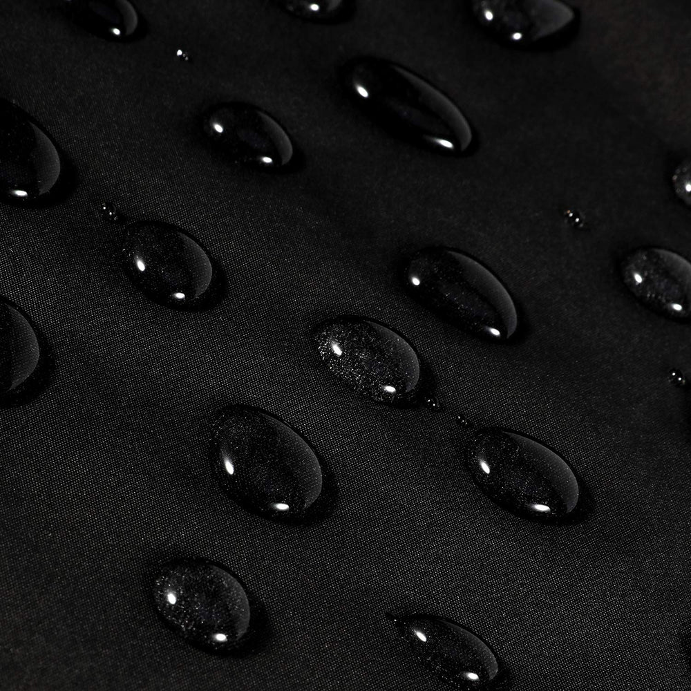Oak Leaf hair cutting cape fabric close-up highlighting water-resistant material.