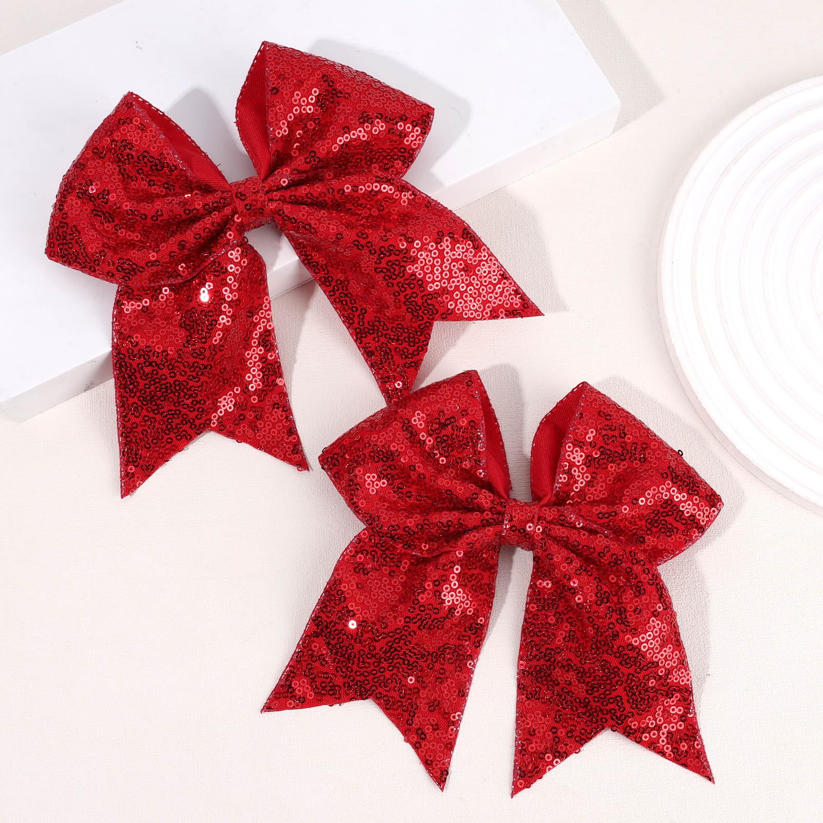 OAOLEER red glitter bow clips hold hairstyles through tournaments and events.