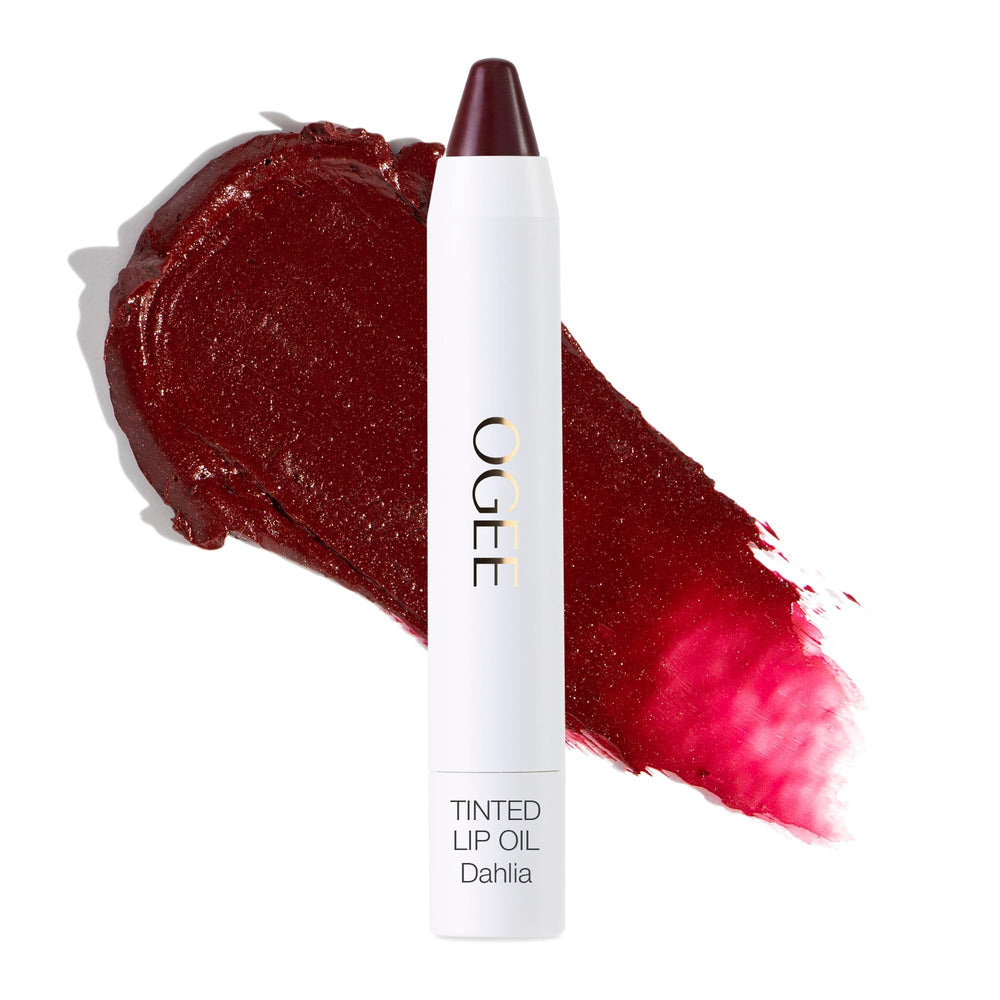 Ogee Dahlia lip oil tube application shows sheer burgundy tint and nourishing oils.