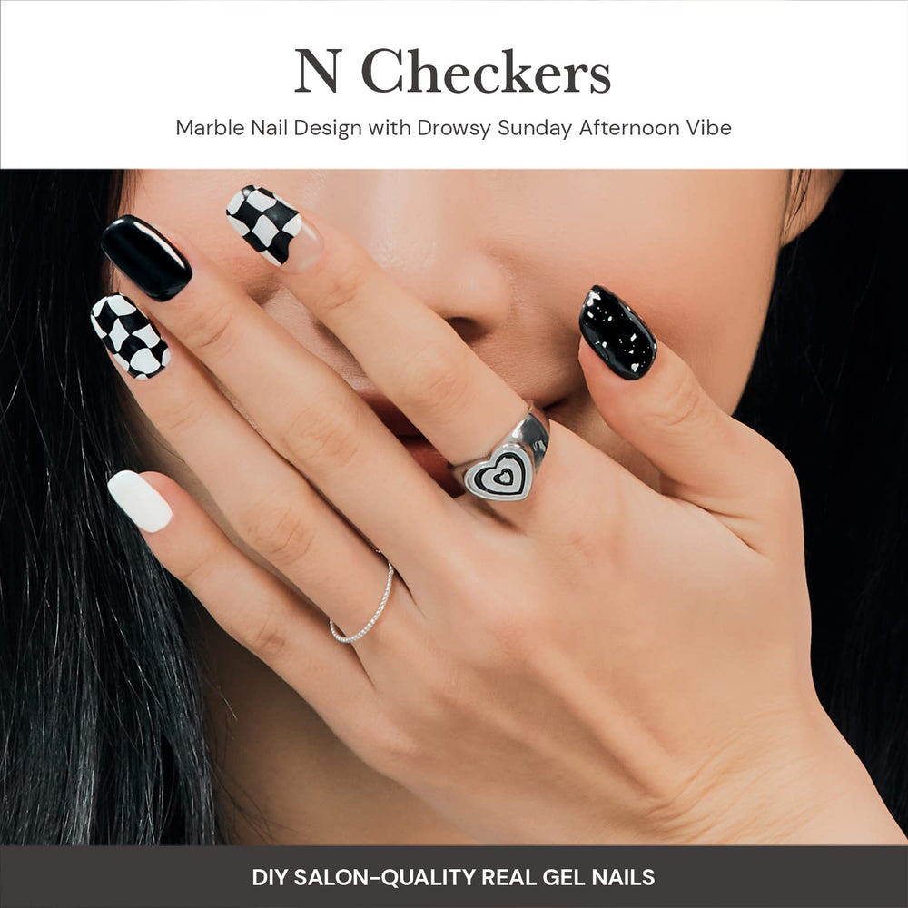 ohora semi cured gel nail strips n checkers dark pattern on hands for quick DIY manicure