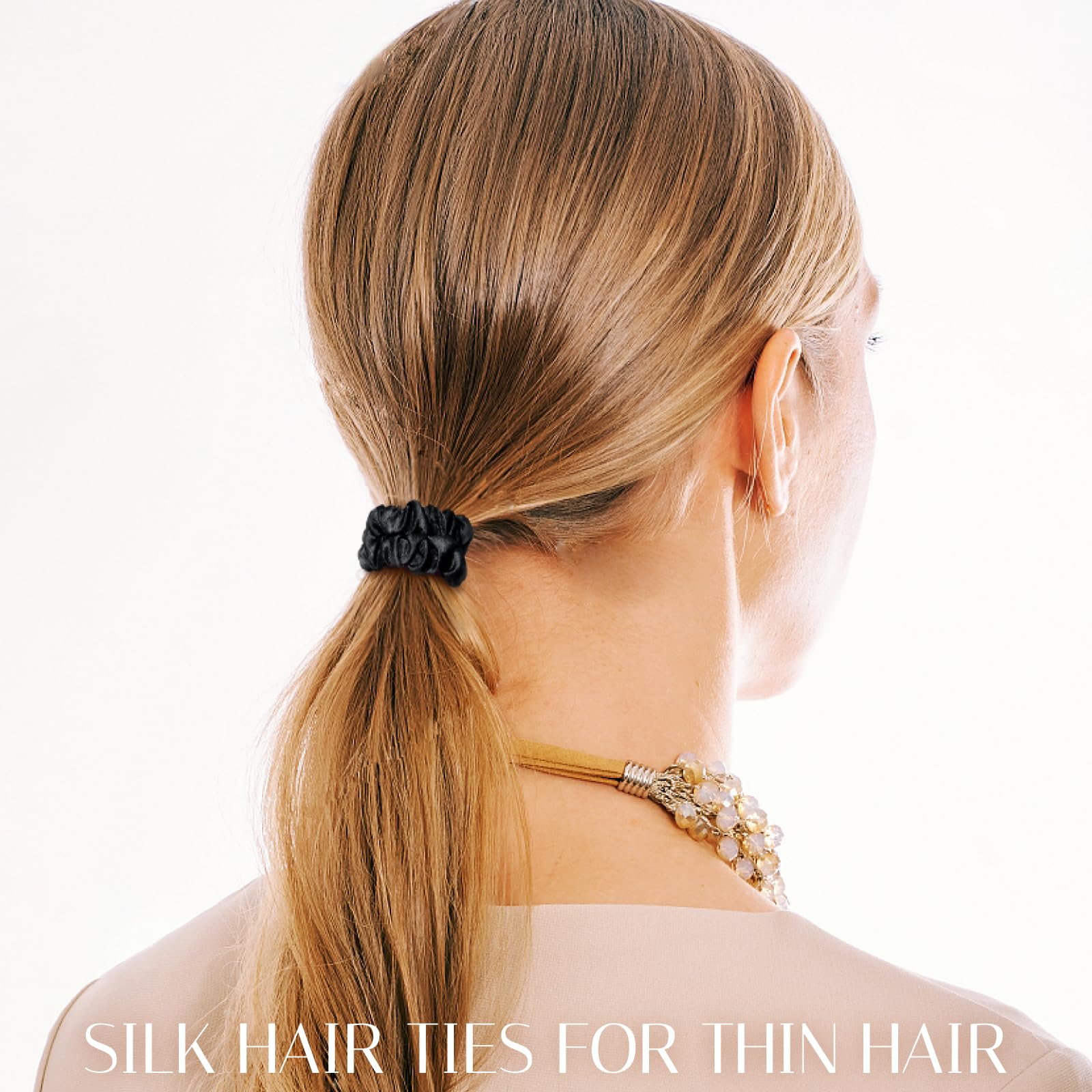 OLESILK silk hair ties on hand; reveals skinny design for secure, crease-free ponytails.