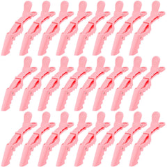 Ondder pink alligator clip for hair sectioning with secure hold during styling.