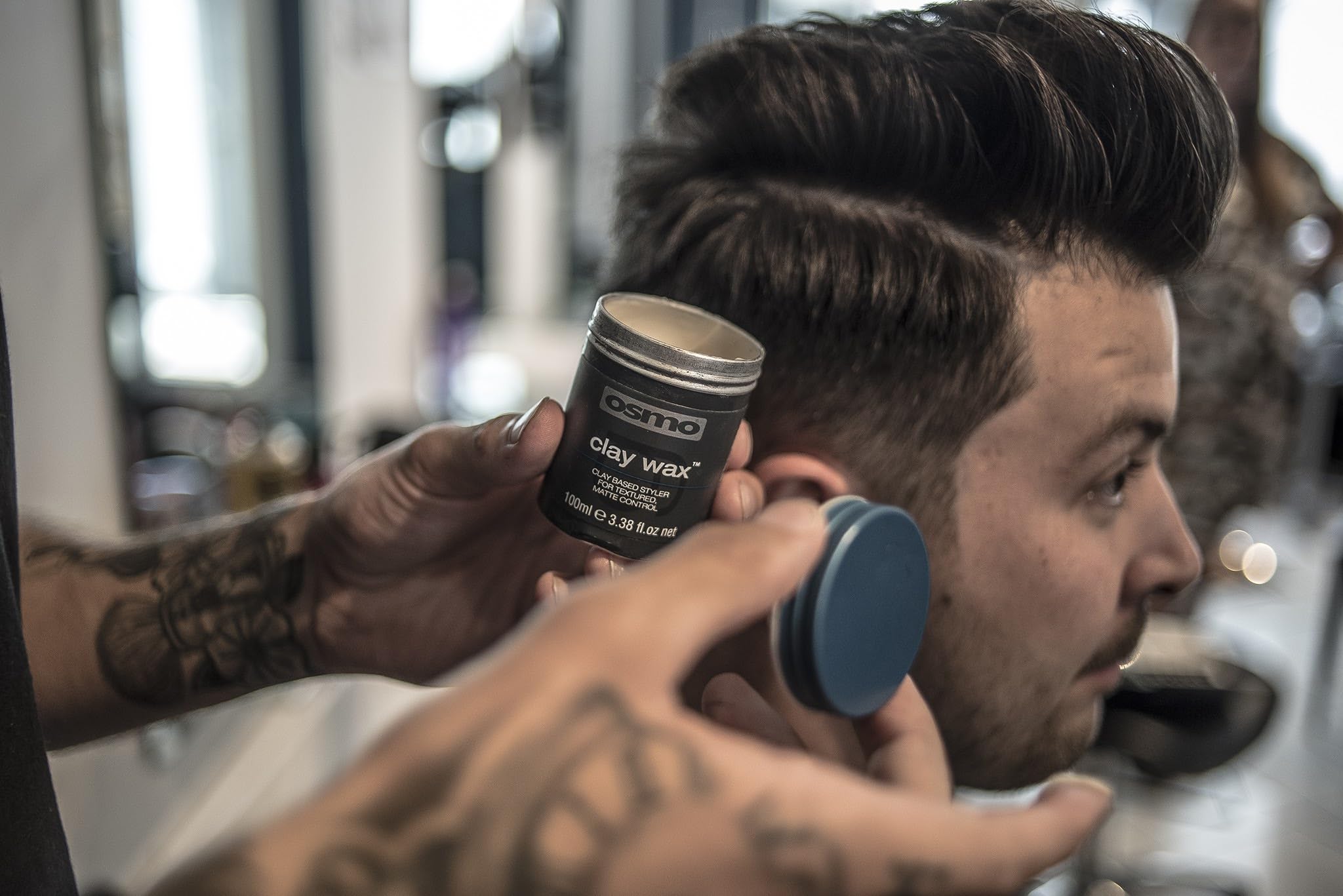 Osmo Firm Hold Clay Wax on hair model displaying defined texture