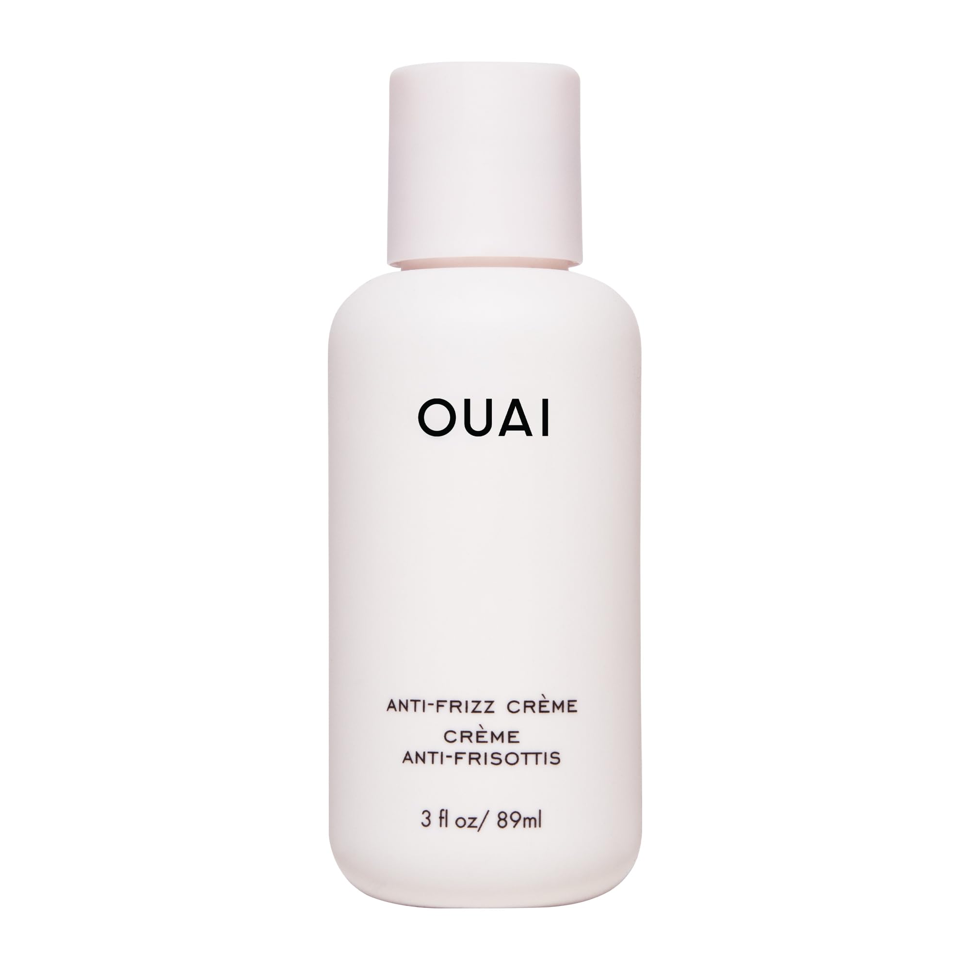 OUAI anti-frizz cream travel size bottle shows portable frizz control for on-the-go styling.