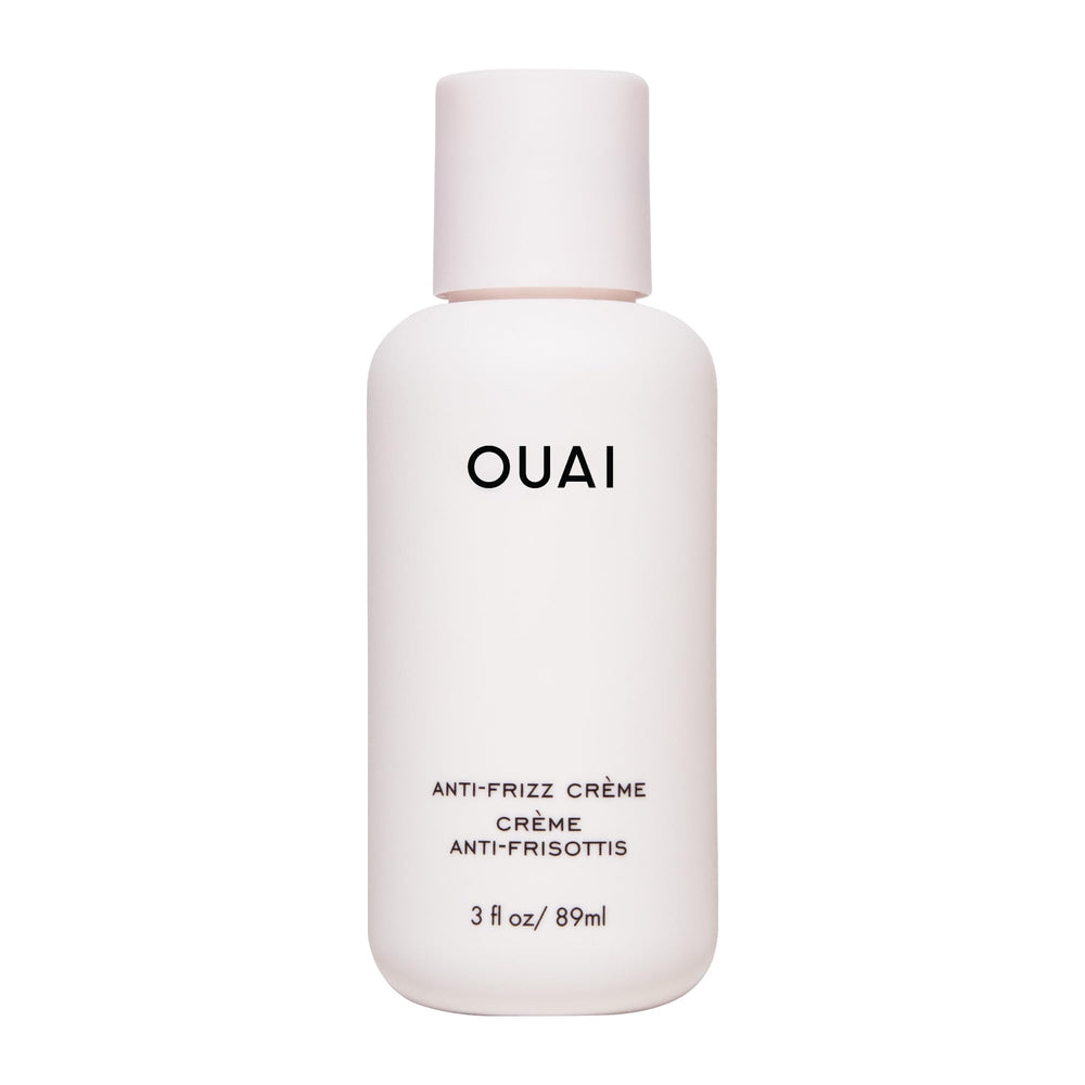 OUAI anti-frizz cream travel size bottle shows portable frizz control for on-the-go styling.