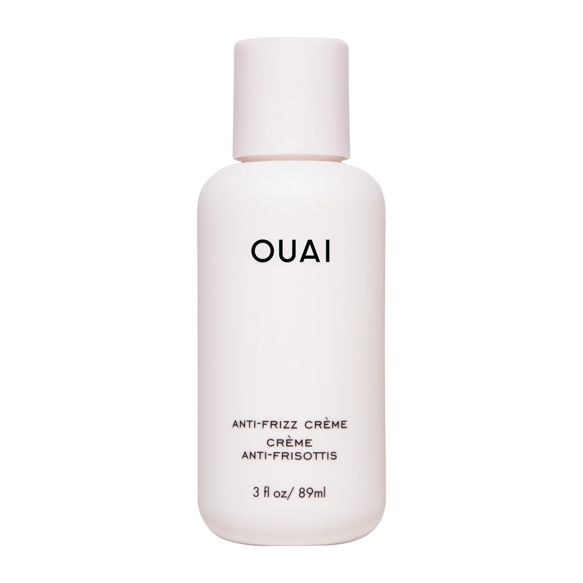 OUAI anti-frizz cream travel size bottle shows portable frizz control for on-the-go styling.