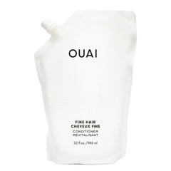 OUAI Fine Hair Conditioner Refill bottle closeup shows glossy hair-softening potential for volume and shine.