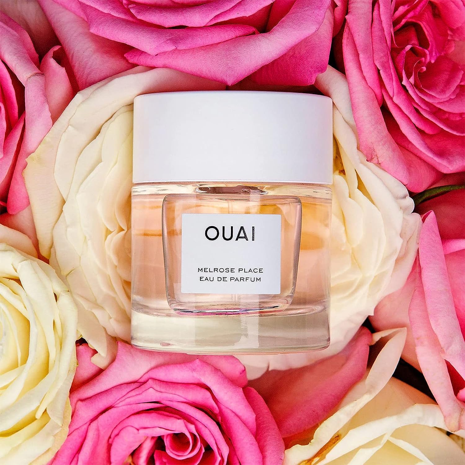 OUAI Melrose Place spray gesture shows easy, lightweight application for daily wear.