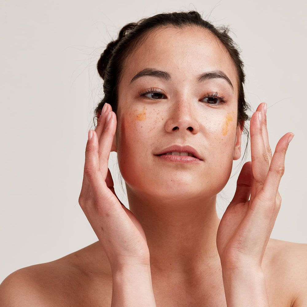 PAI SKINCARE Rosehip BioRegenerate oil on hand for nourishing daily glow.