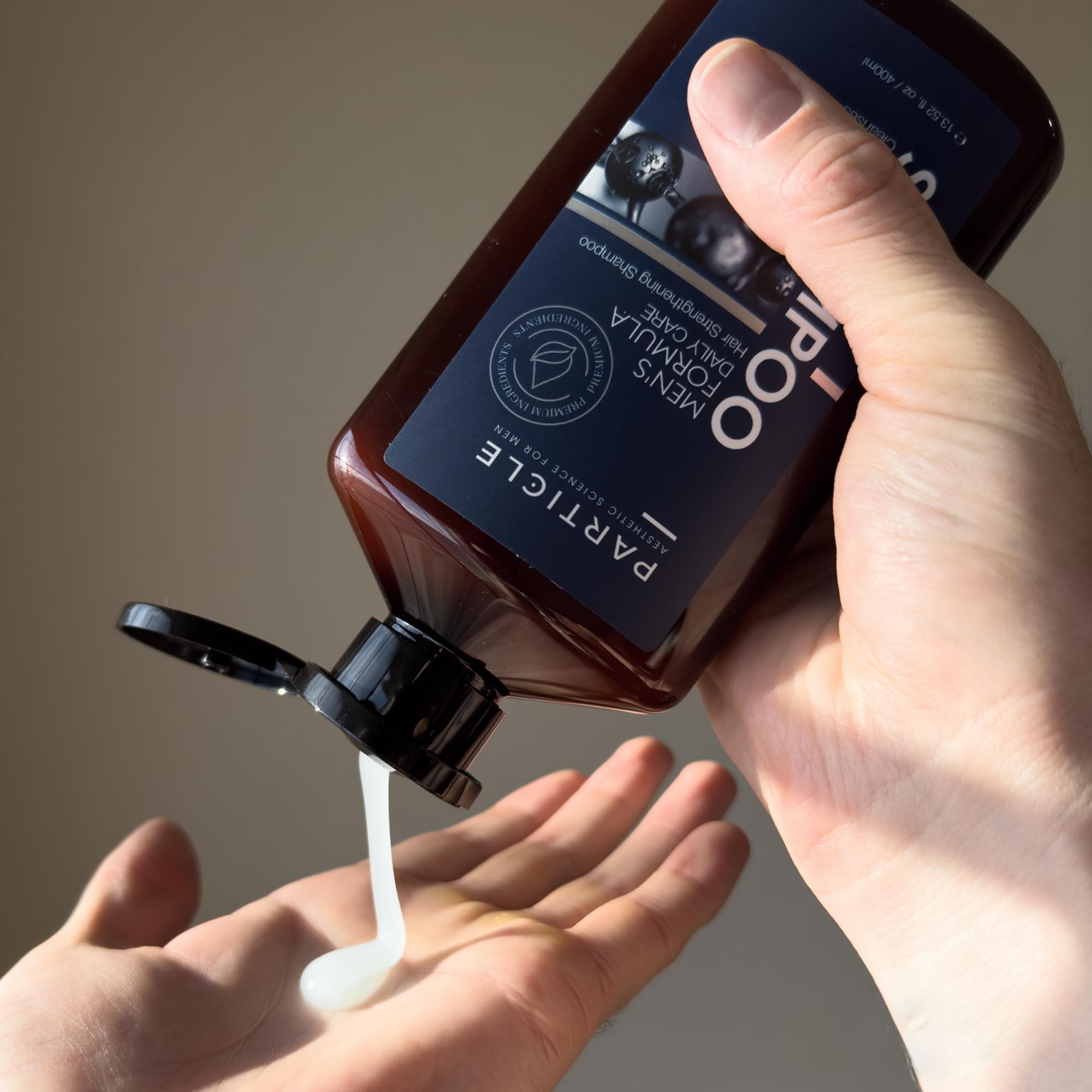Particle Hair Thickening Shampoo for Men product shot highlights invigorating fragrance