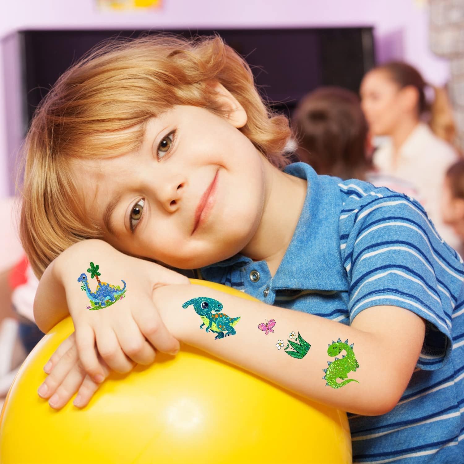 PARTYWIND dinosaur party setup shows kids wearing sparkle tattoos for photo-ready moments.