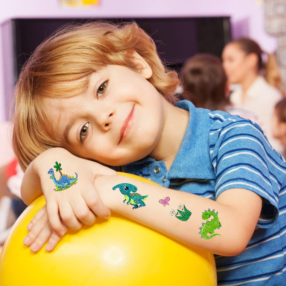 PARTYWIND dinosaur party setup shows kids wearing sparkle tattoos for photo-ready moments.