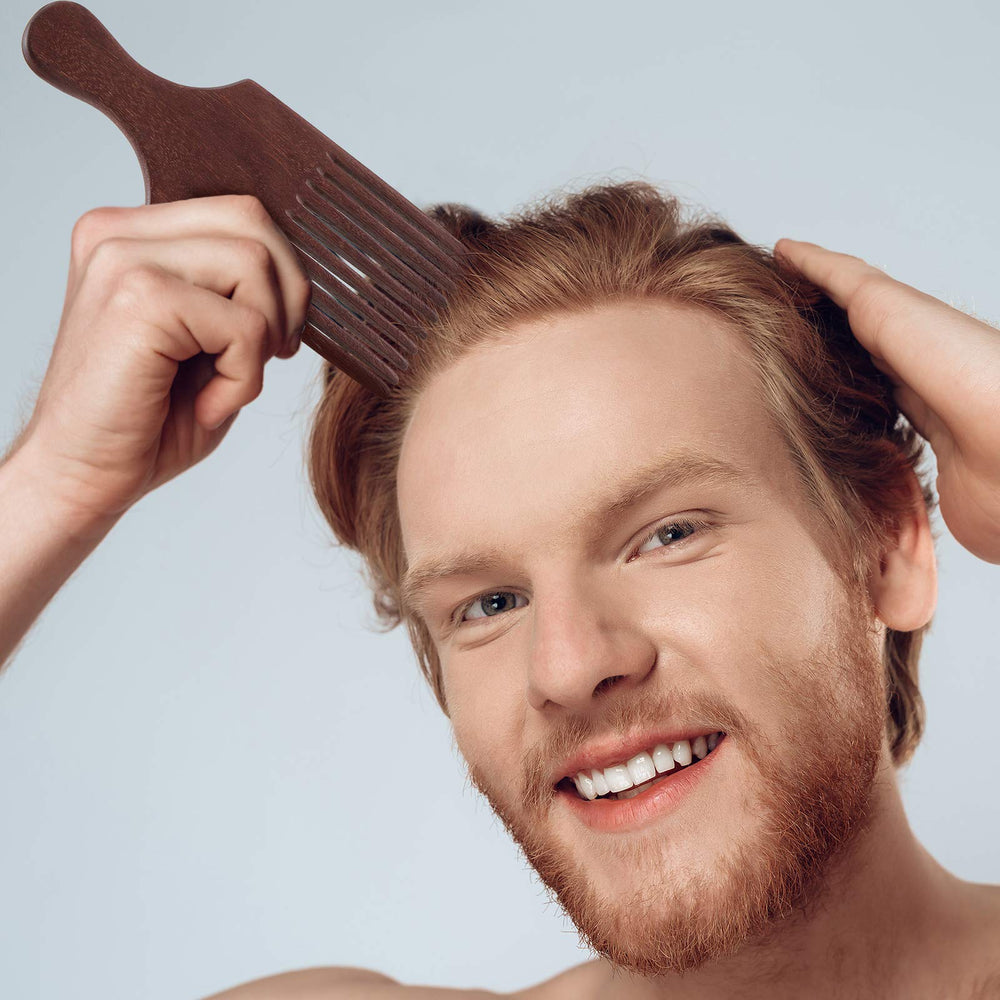Patelai hair pick comb in hand with ergonomic handle for easy grooming