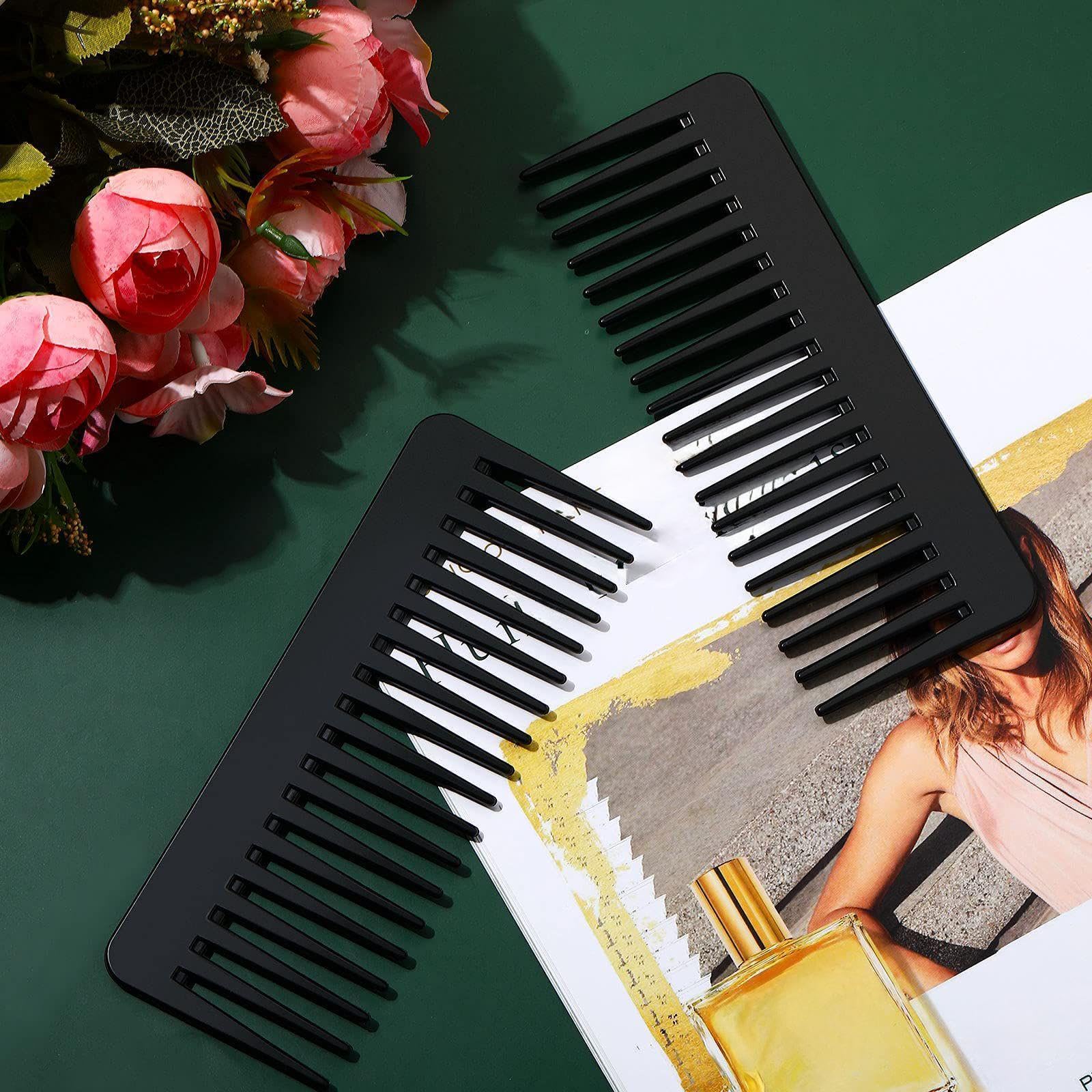Patelai detangler comb in black fits the palm for everyday grooming.