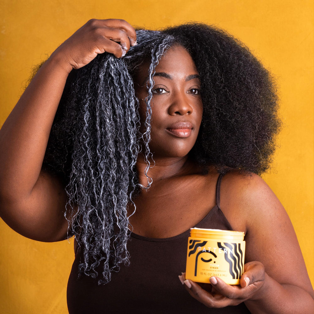 PATTERN Beauty curl definition closeup demonstrates smooth, frizz-free shine.