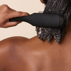 PATTERN Beauty Shower Brush aids curl clumping and definition in wet hair.