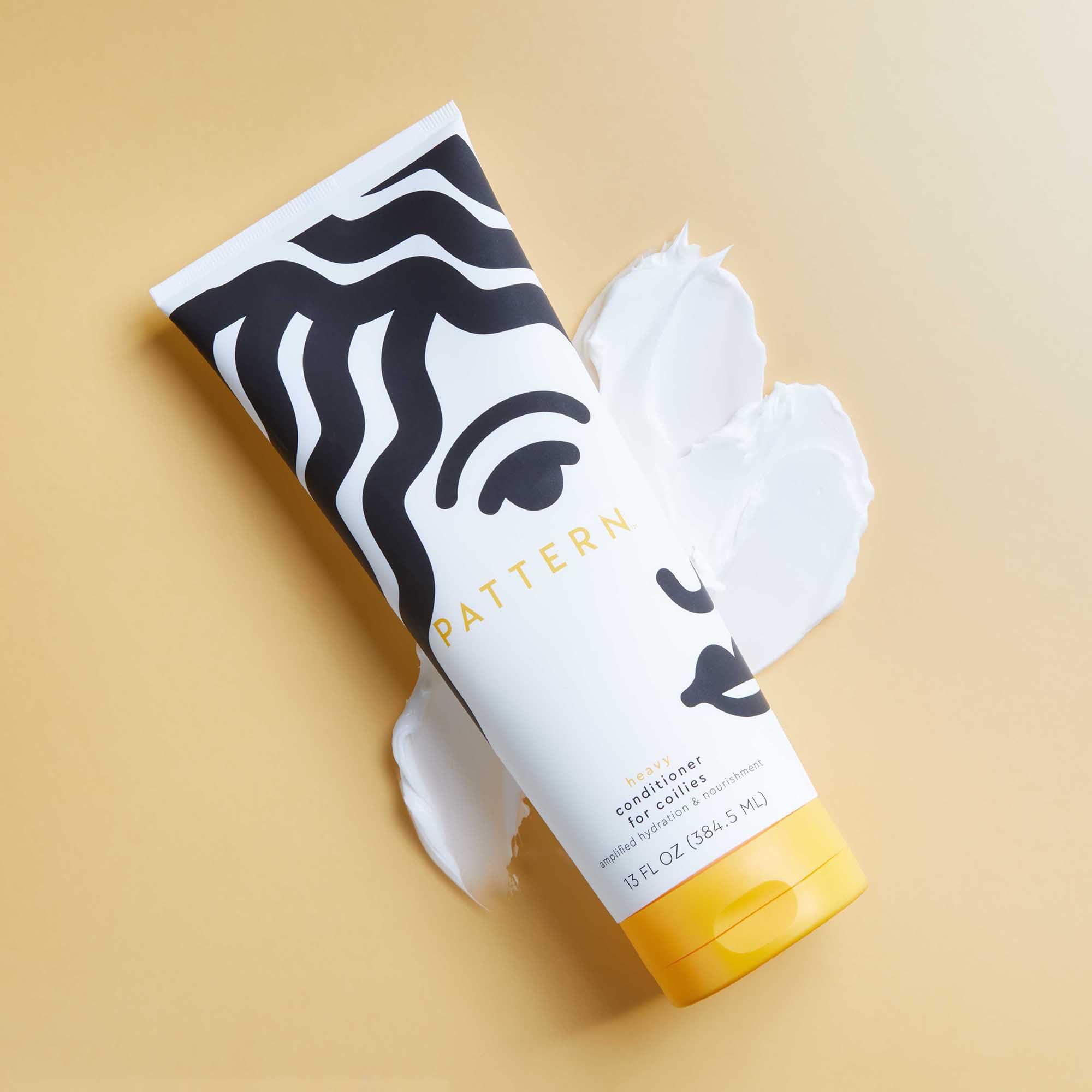 Pattern Heavy Conditioner model hair scene suggests healthier curls after conditioning.