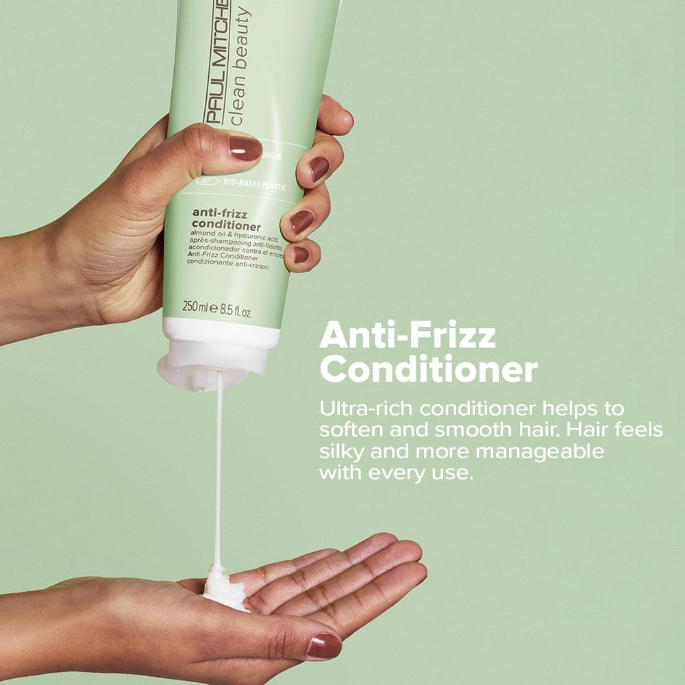 Paul Mitchell Clean Beauty Anti-Frizz Conditioner applied to textured hair for smoothness.