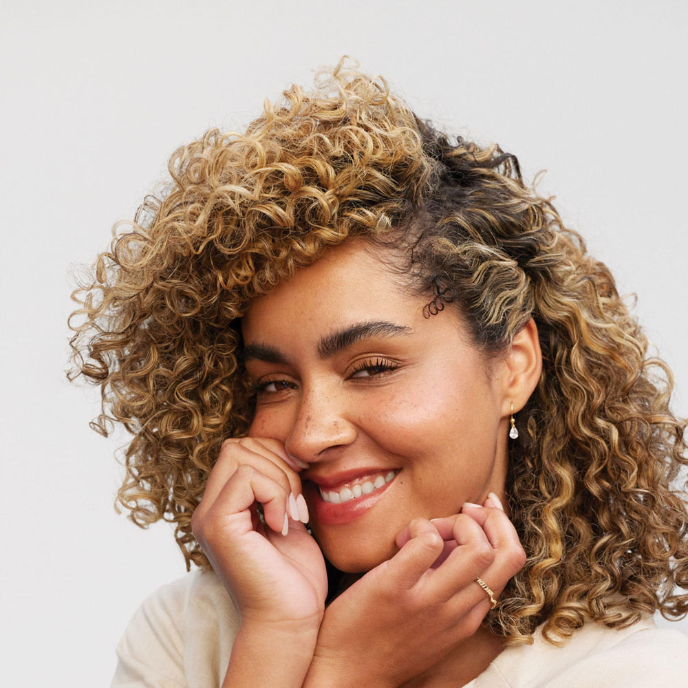 Paul Mitchell Clean Beauty Anti-Frizz Leave-In Cream in dispenser enables easy application.