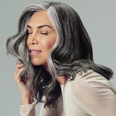 Paul Mitchell Extra-Body Finishing Spray mist being dispensed for flexible hold.