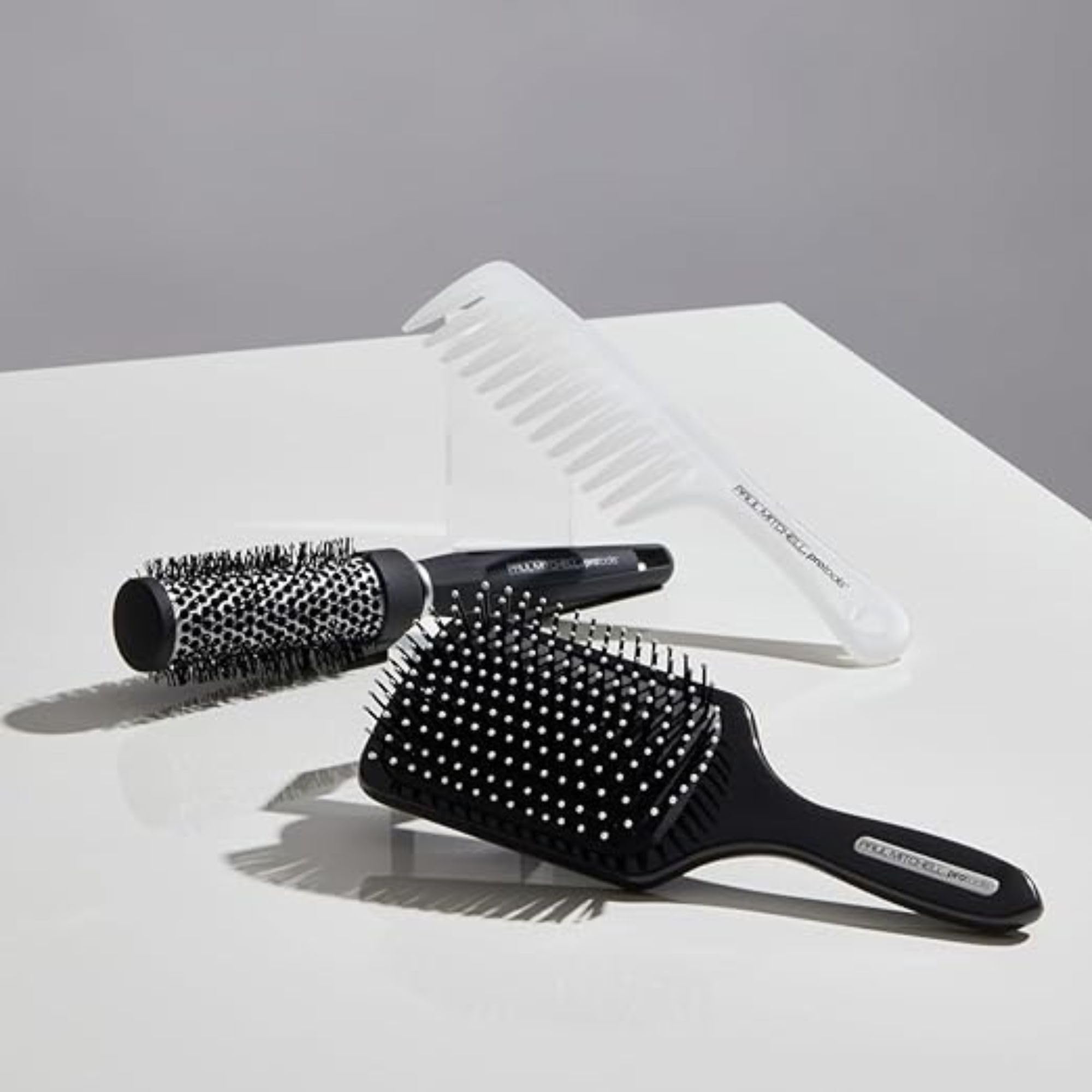 Paul Mitchell Pro Tools 427 Paddle Brush side view in use promotes volume during blow-dry