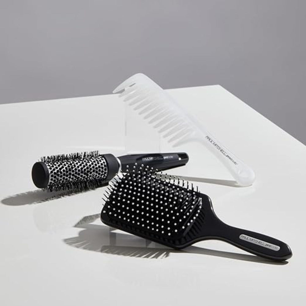 Paul Mitchell Pro Tools 427 Paddle Brush side view in use promotes volume during blow-dry
