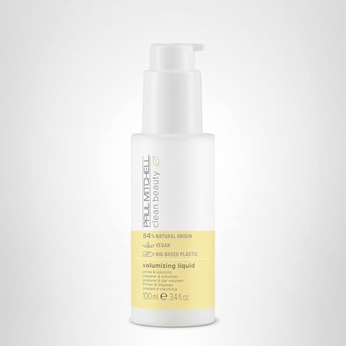 Paul Mitchell tabletop product layout shows sleek volumizing liquid presentation.