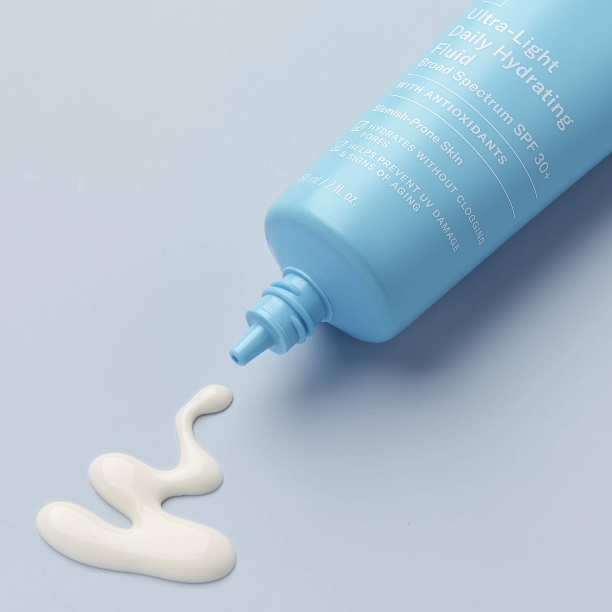 Paula's Choice 2oz sunscreen travel bottle on bathroom shelf suggests convenient daily protection.