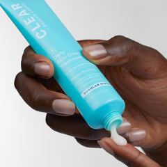 Paula's Choice CLEAR cream in hand highlights easy daily acne management.