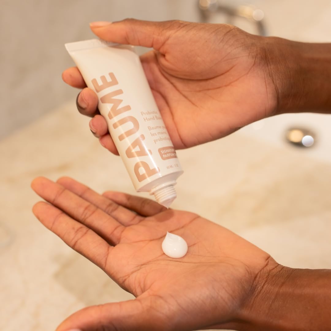 PAUME probiotic hand balm on hands during use illustrates fast hydration.
