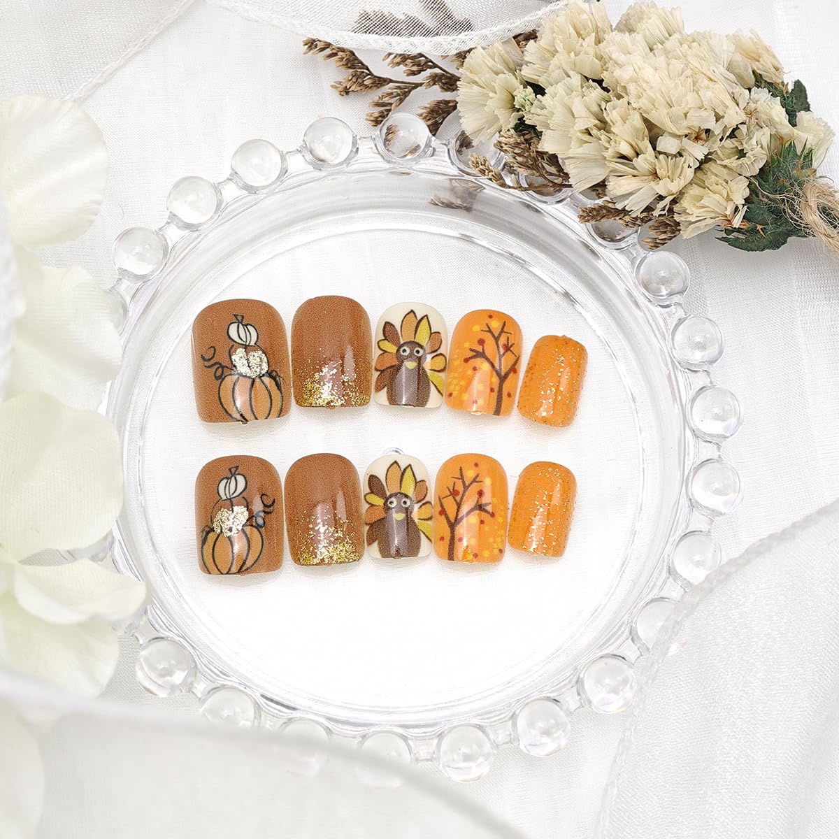 PBPCGBW gold glitter acrylic nails shining in a chic manicure shot.