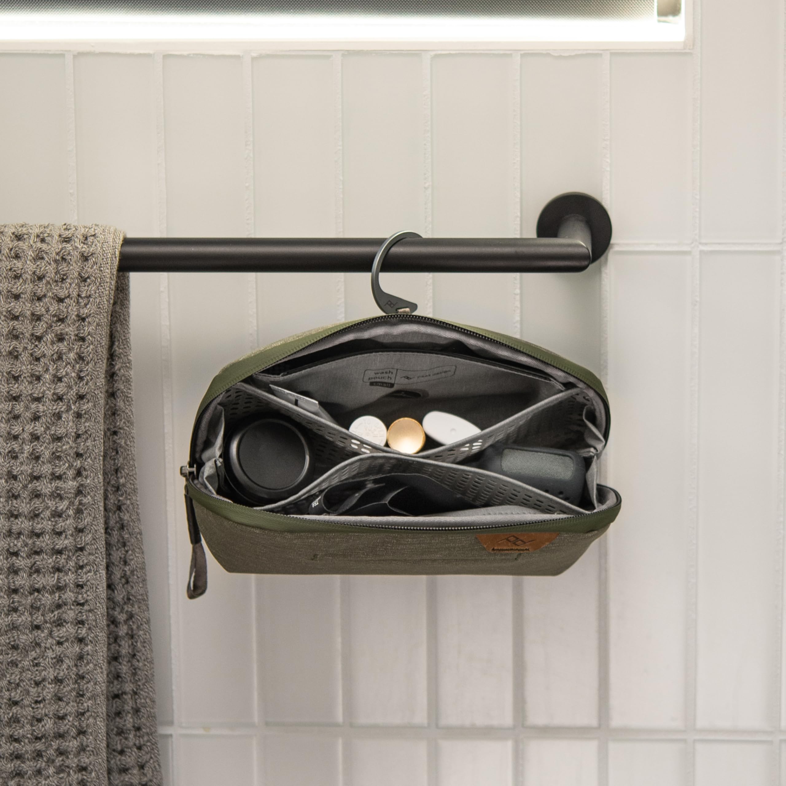 Peak Design Small Wash Pouch Sage standing upright on counter for full access