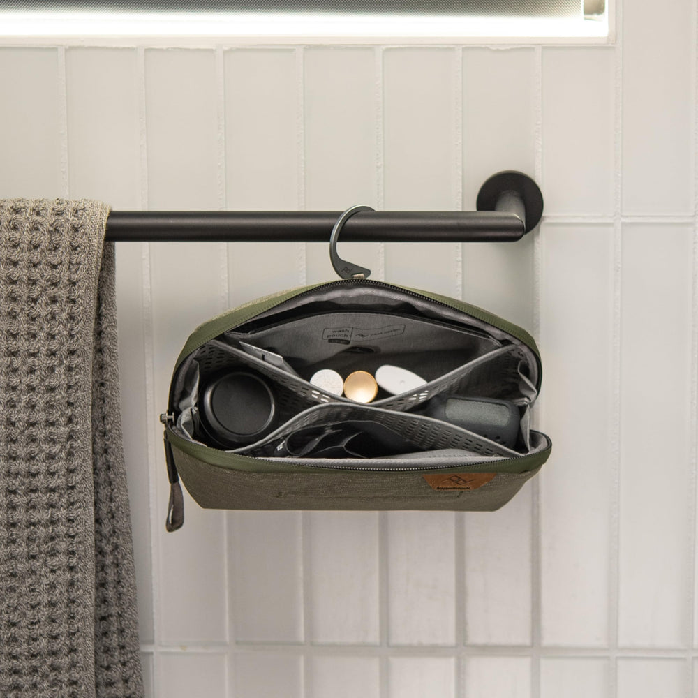 Peak Design Small Wash Pouch Sage standing upright on counter for full access