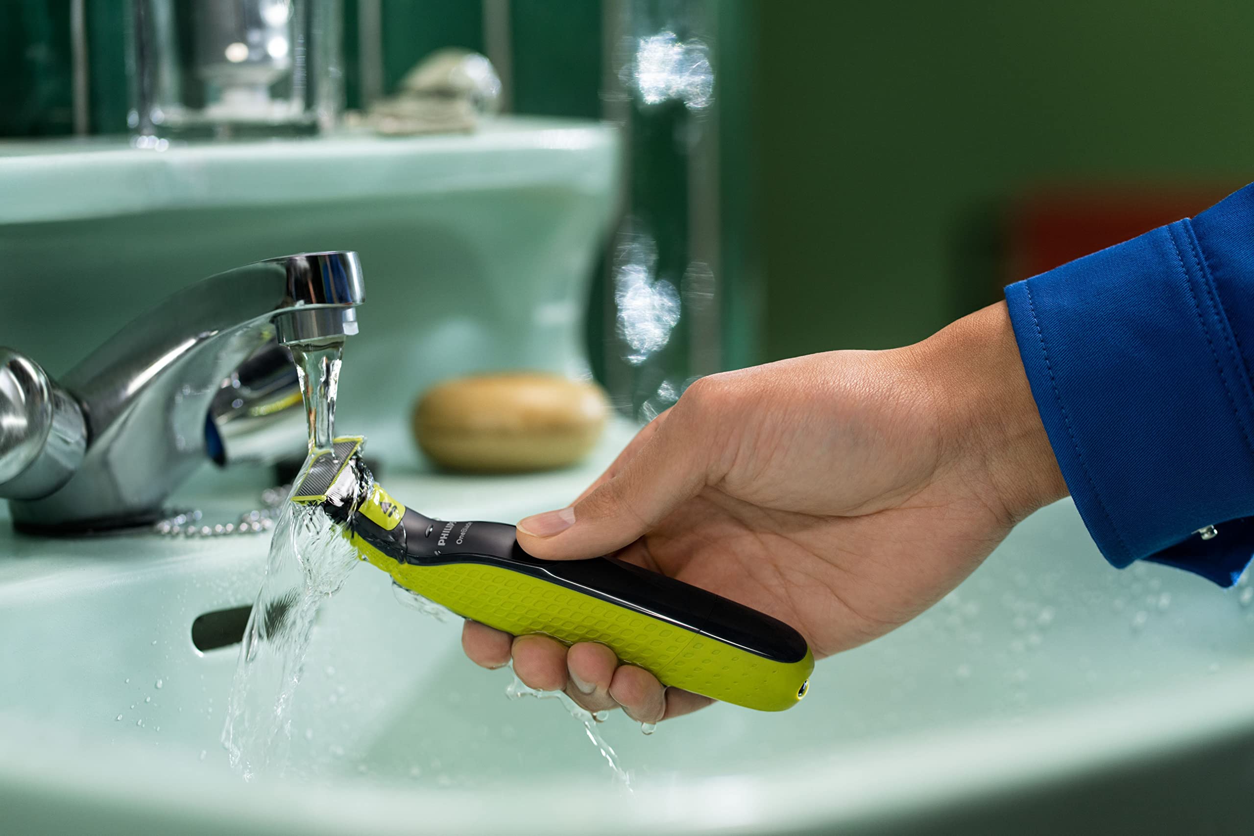 Philips OneBlade in-use staging demonstrates quick replacement during grooming routines.