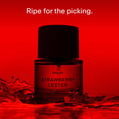 PHLUR Strawberry Letter bottle close-up highlighting the glass and fruity notes.