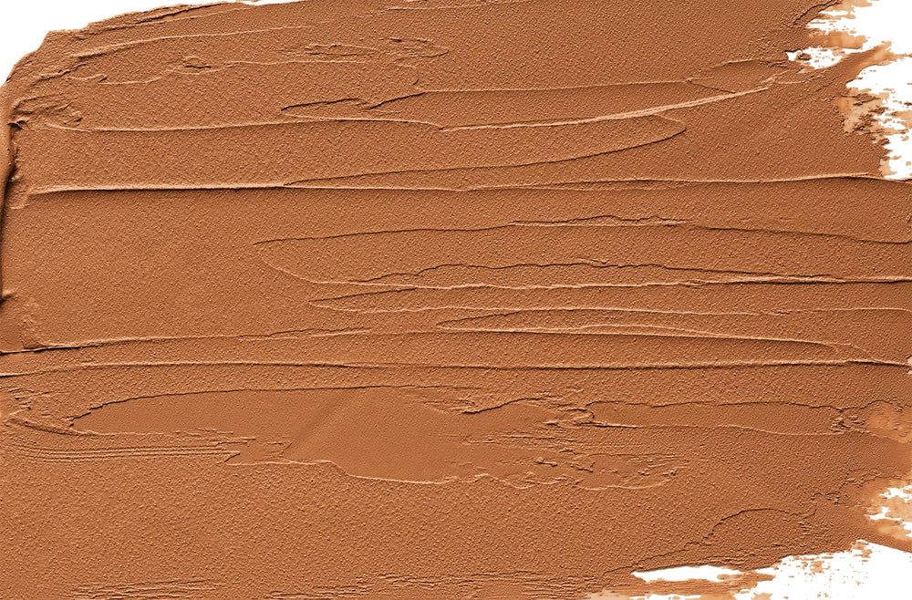 Physicians Formula Organic Wear bronzer stick close-up shows creamy texture for blending.