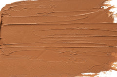 Physicians Formula Organic Wear bronzer stick close-up shows creamy texture for blending.
