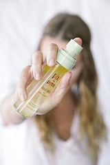 Pixi Beauty Glow Mist applied to hair for a luminous, healthy-looking shine.