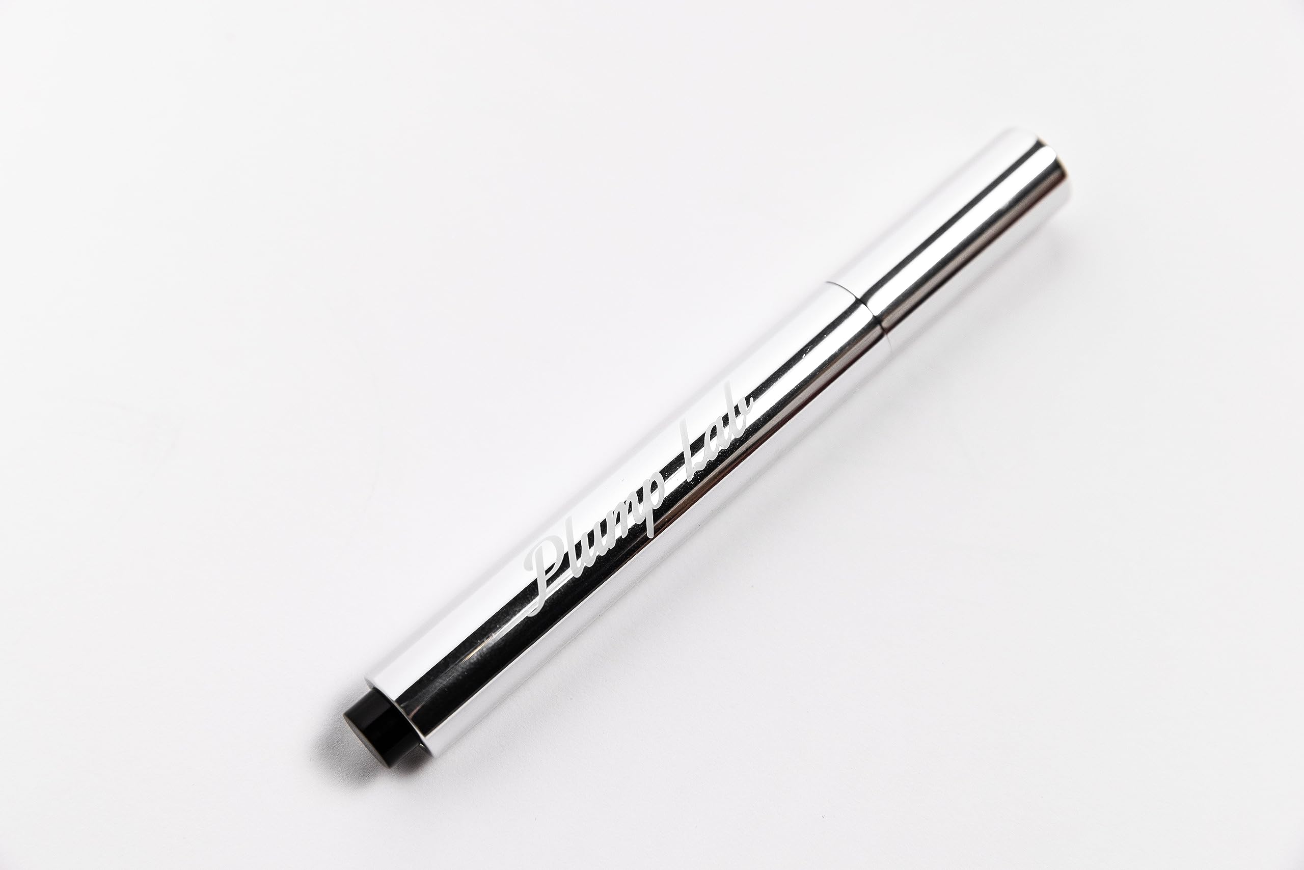 Plump Lab Lip Plumper Gloss on lips closeup shows defined contour and shine.