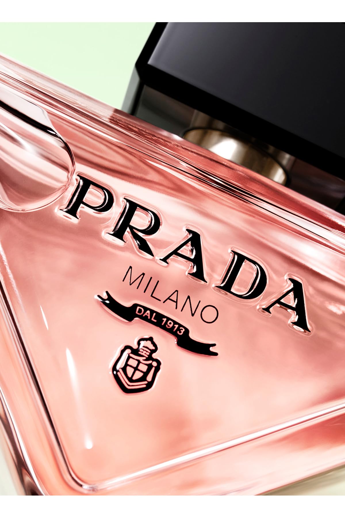 Prada Paradoxe amber liquid tilt—sensory warmth with vanilla and jasmine.