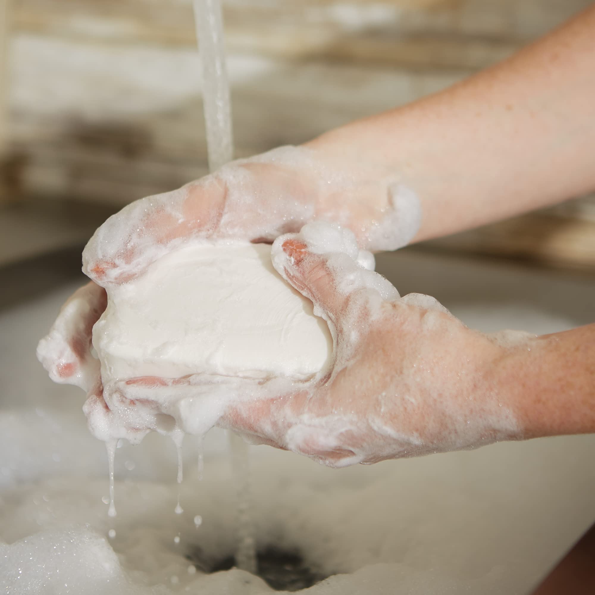 Pre de Provence Verbena soap bar in-bath lather demo; creamy foam for skin.