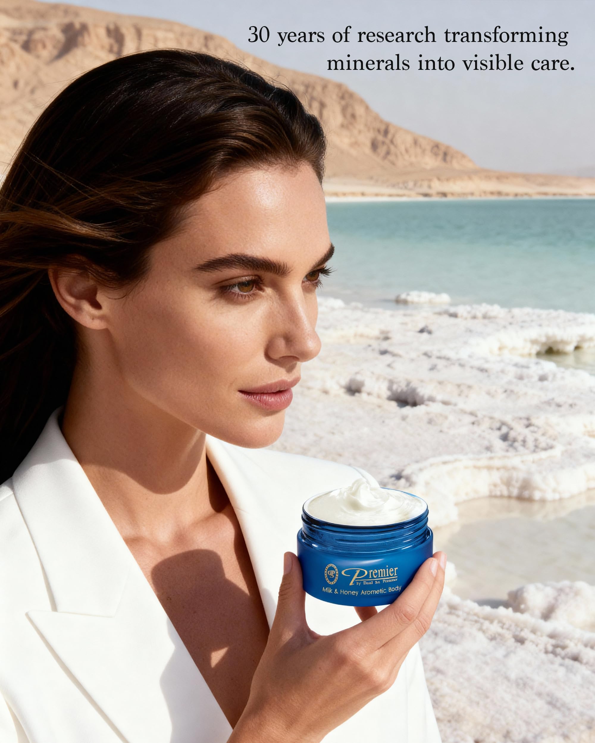 Premier Dead Sea aromatic body butter application on hands demonstrates quick-absorbing hydration.