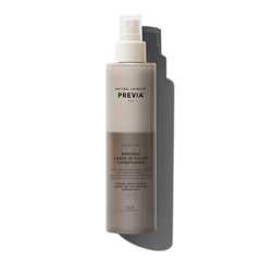 PREVIA Hydrating Biphasic Leave-In Spray bottle on shelf for frizz control and detangling.