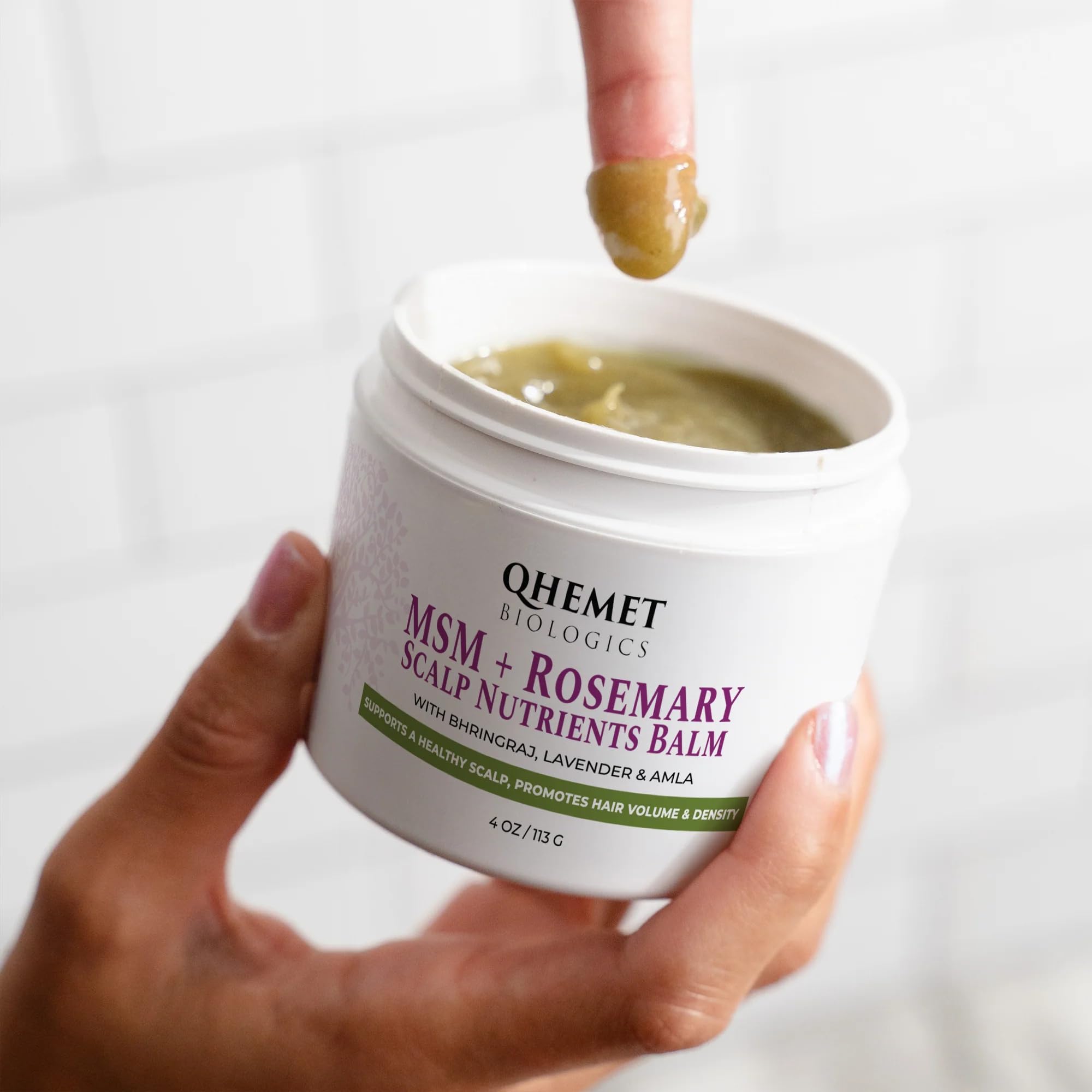 Qhemet Biologics balm applied to scalp for targeted, easy nourishment.