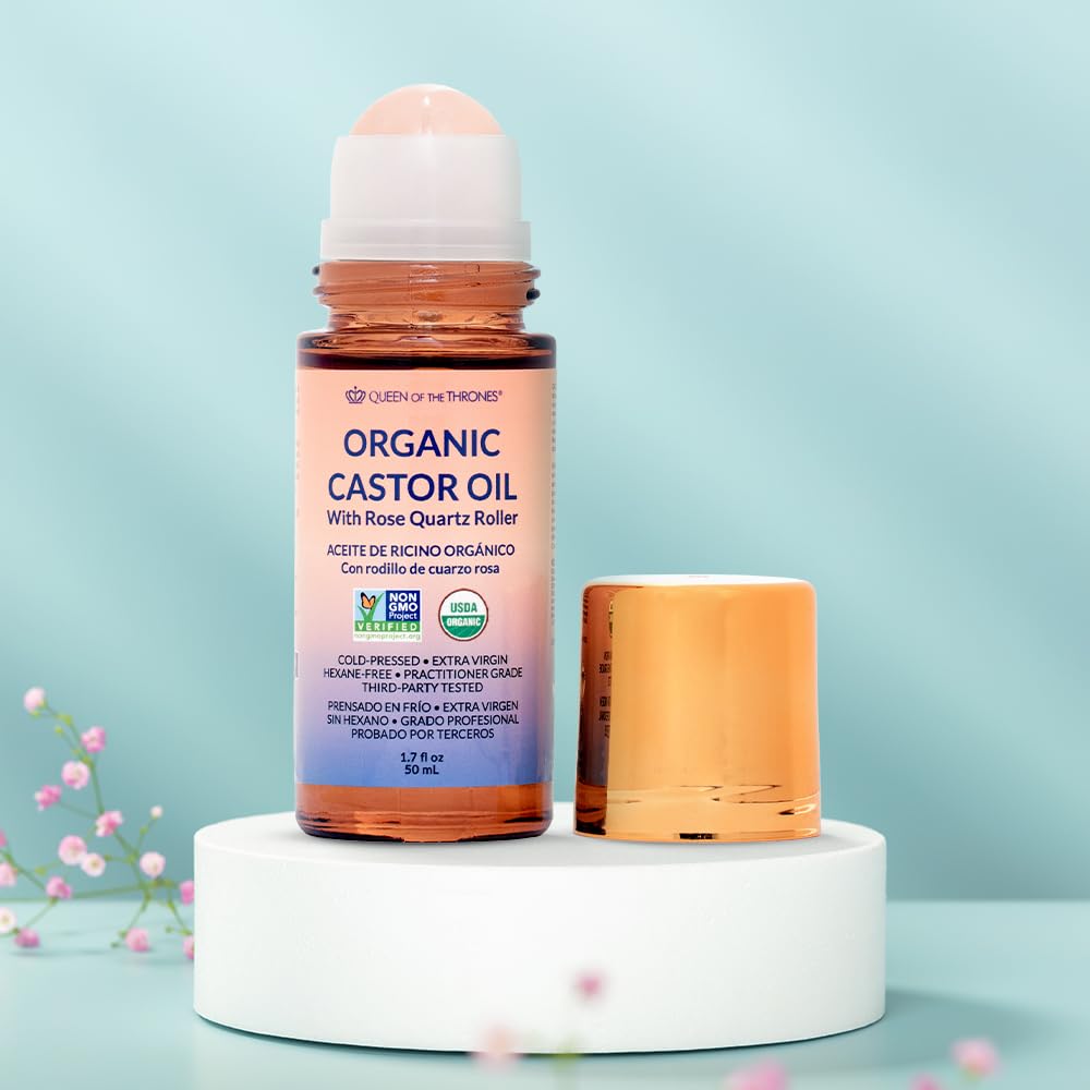 Castor oil pack setup with Queen of the Thrones roll-on for precise topical use