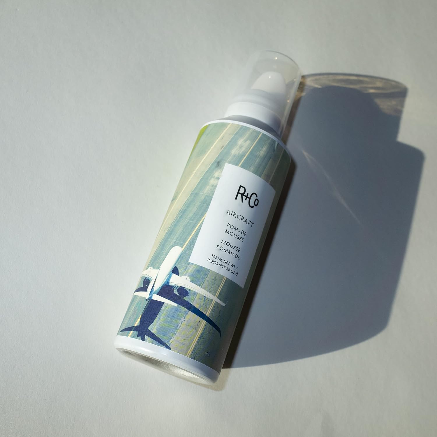 R+Co AIRCRAFT Pomade Mousse foam dispensed, ready for styling and definition.