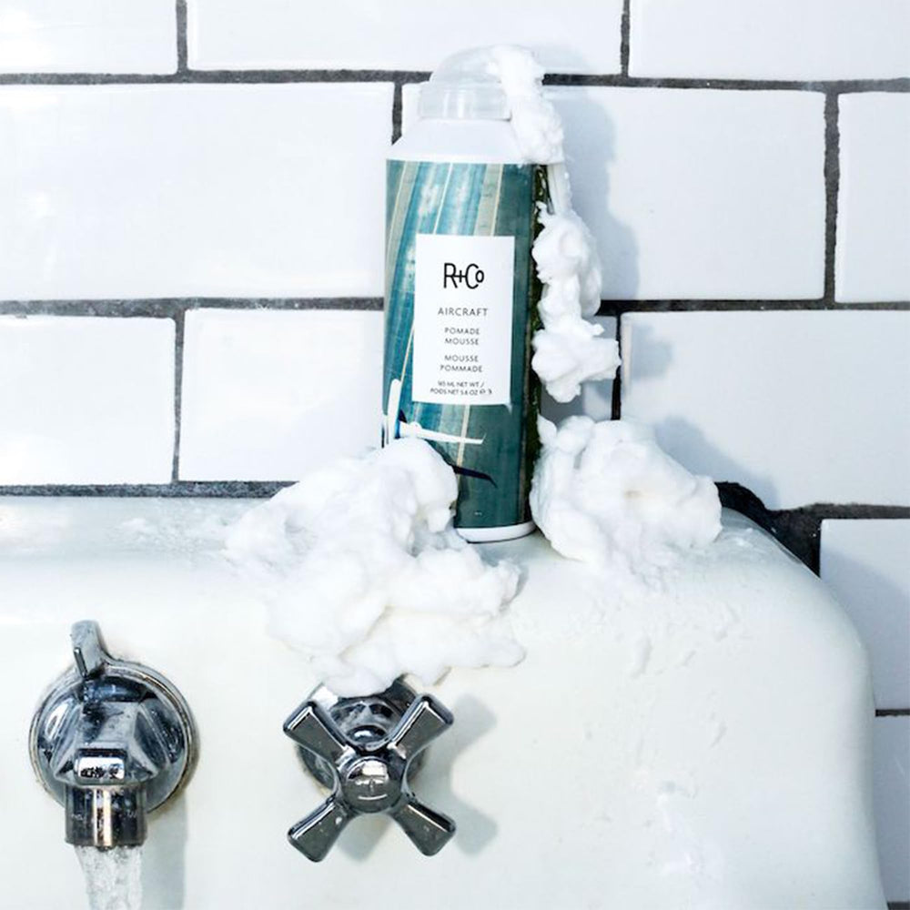 R+Co AIRCRAFT Pomade Mousse Neem-Papaya blend for moisture and volume.